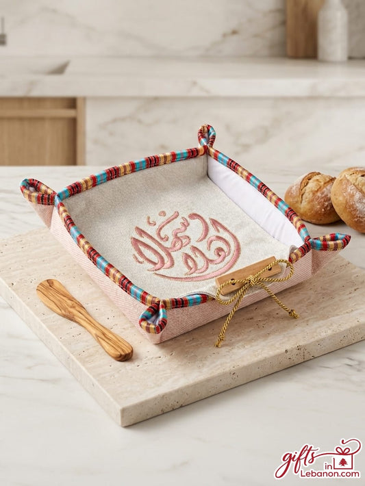 Embroidered Ahlan Wa Sahlan fabric bread basket with traditional trim and wooden spreader