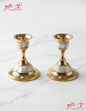 A pair of traditional handcrafted brass candlesticks with mother-of-pearl inlay