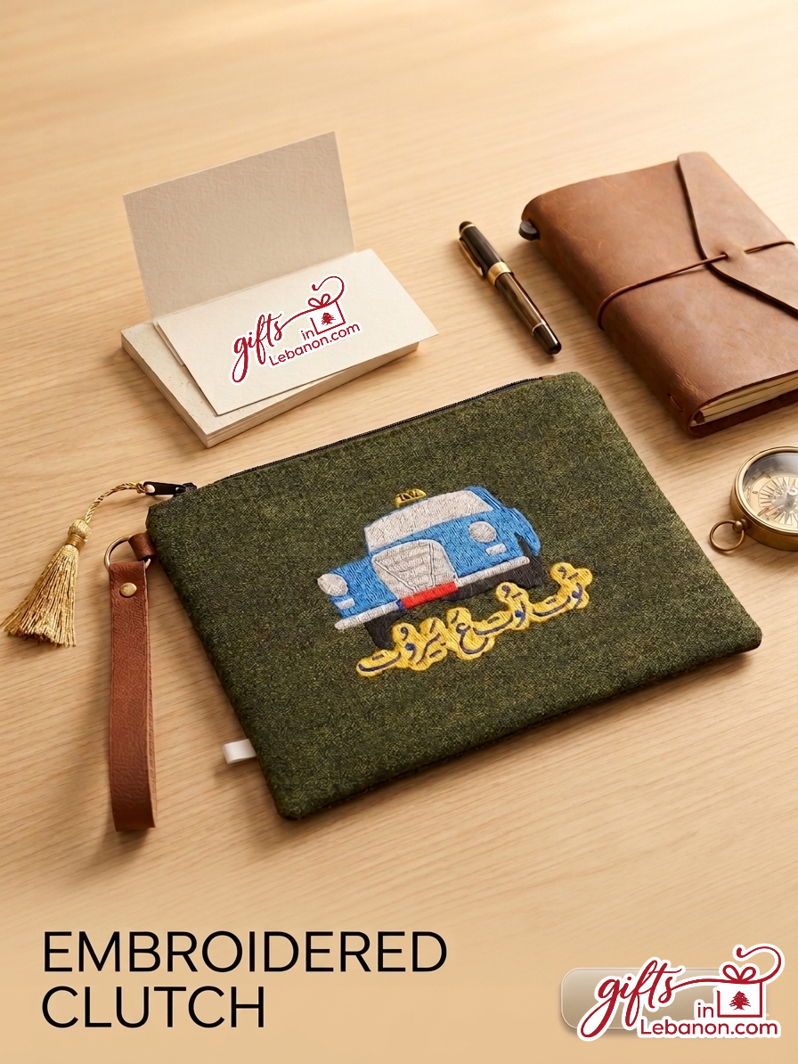 Hand-embroidered green clutch featuring a classic blue Beirut service taxi and Arabic calligraphy