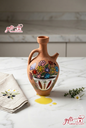Hand-painted traditional Lebanese clay Brik jug for olive oil on a marble counter