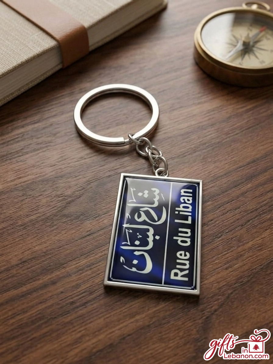 Rue du Liban blue street sign keychain on a wooden table