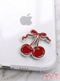 Glossy red enamel cherry sticker with a bow on a clear phone case